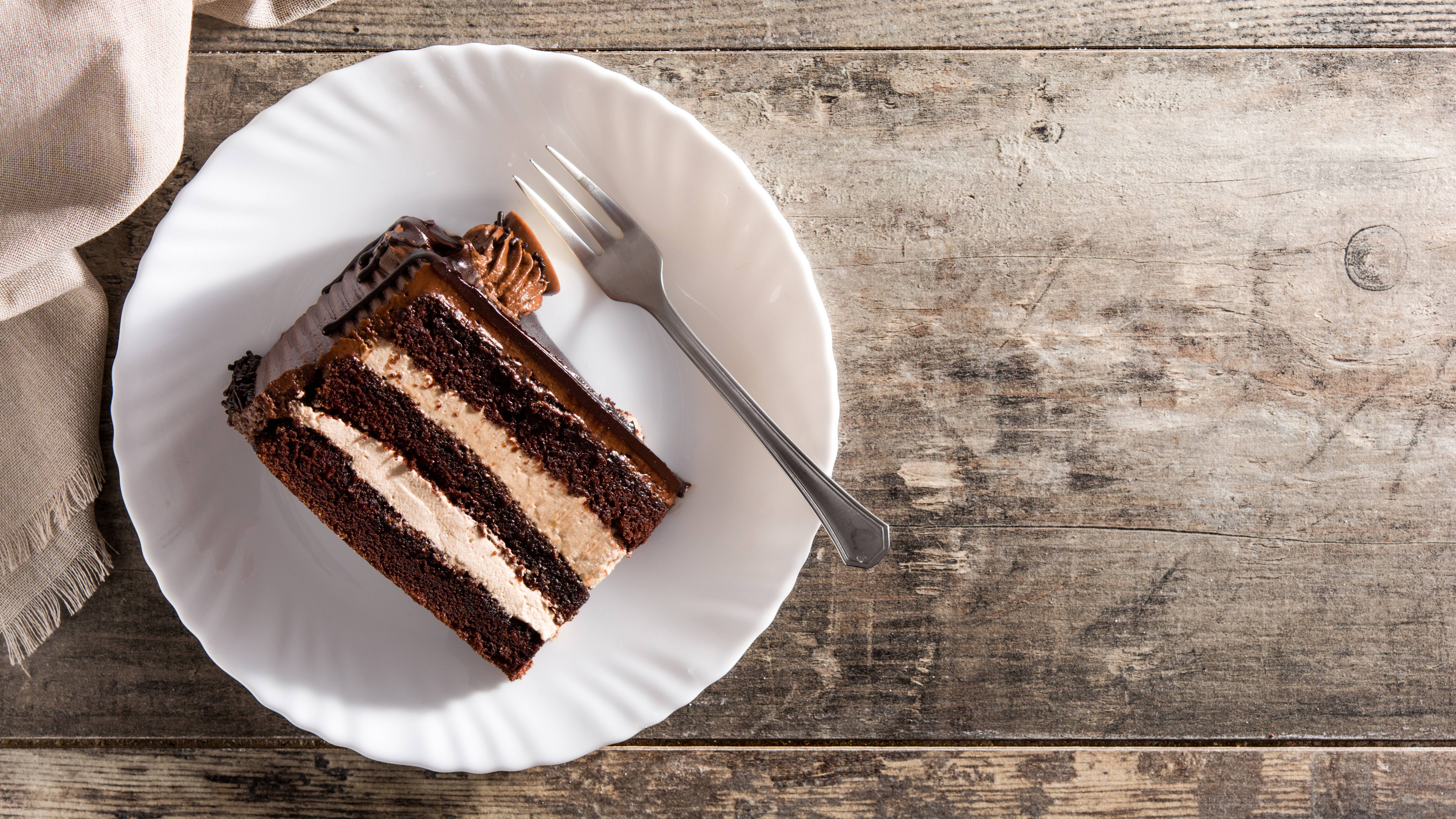 A piece of chocolate cake on a white plate